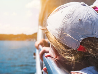 Little Girl Looking over a Lake on a boat