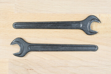 Two old spanners on a wooden table