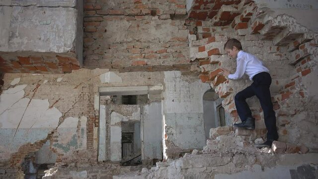 Boy hides in a ruined building after the war, lost, fear, loneliness, threat, game