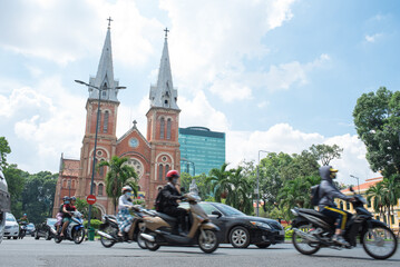 Motorcycles and Notre-Dame Cathedral in Saigon,...