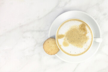 Cup of coffee with milk and butter cookie