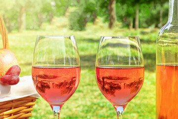 Two glasses of rose wine at picnic on sunny day