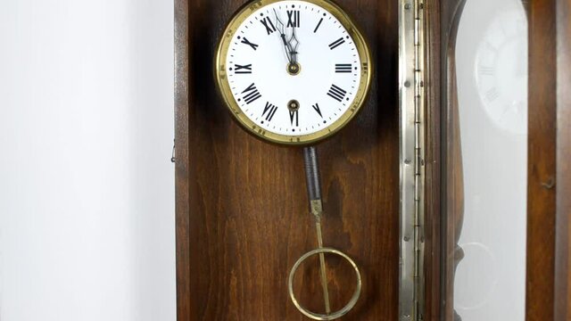 Wall clock in a retro style with a swaying pendulum