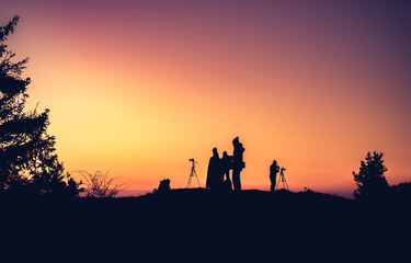 Fototapeta na wymiar Silhouettes of unidentified photographers on the mountain peak in the morning
