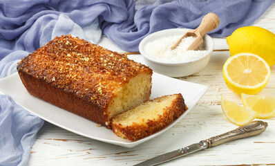 Homemade coconut citrus cake with lemon syrup. Dessert for gourmets. Selective focus