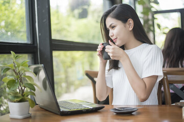  Beautiful business girl working with tablet , smartphone and drinking coffee in coffee shop