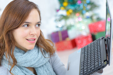 Lady using laptop at Christmas