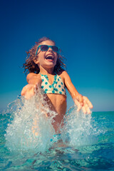 Happy child playing in the sea