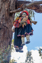 Stuffed puppets hanging on a tree at Inca's ruins of Q'enqo near Cuzco, Peru.