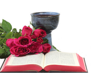 Chalice, roses and open bible on white background