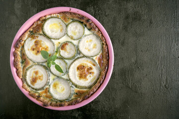 rustic pie with zucchini, on a black background