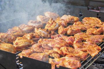 barbecueing on beautifull sunny day. steaks, chicken legs close-up
