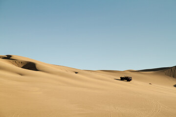 Fototapeta na wymiar Dune buggy rides the sand dunes in Huacachina desert, Peru