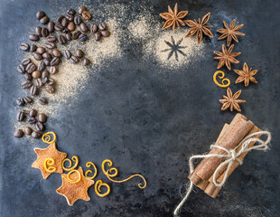 Grains of coffee, anise and cinnamon sticks on a dark background. Place for inscription