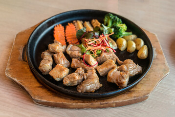 Pork Steak with vegetables in hot pan,teppanyaki Japanese food style