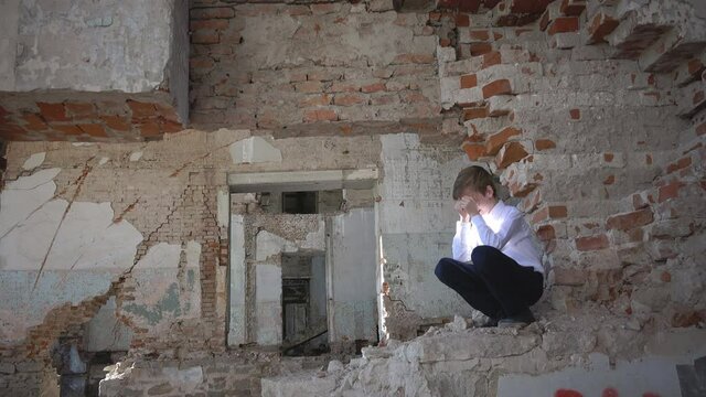 The boy who had the tragedy, he alone in the ruined building after the war, lost, fear, loneliness, threat, loss and grief