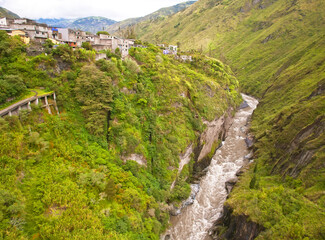 Small Ecuadorian village on the hillside. Wild mountain river in the gorge. Ecuador.