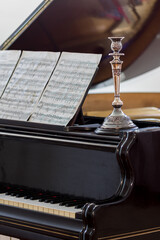 Black classic piano with silver candlestick