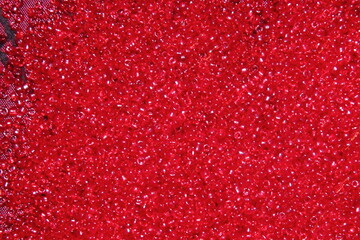 Crimson-red glass beads background - closeup beads texture