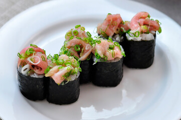 Close up Nori Maki Sushi with chopped tuna on white plate