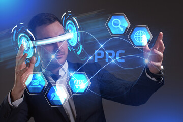 Business, Technology, Internet and network concept. Young businessman working in virtual reality glasses sees the inscription: PPC