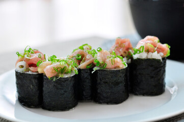 Close up Nori Maki Sushi with chopped tuna on white plate
