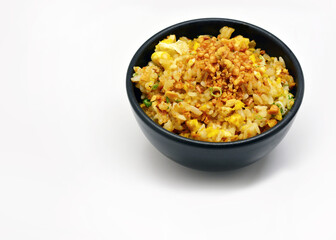 Fried rice with garlic in a black bowl on a white background