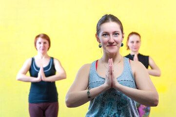 Group of caucasian women practicing yoga in class