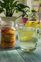 Fototapeta na wymiar Detox citrus infused flavored water. - homemade cocktail with lemon, lime, grapefruit and mint