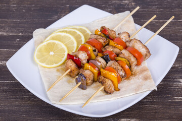 Tasty grilled meat and vegetables on skewer