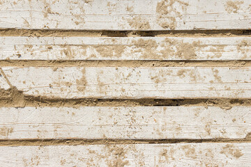 Texture wooden boards in the sand on the beach, top view closeup