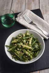 Pasta with vegetables, pesto, and pine nuts