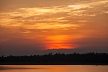 Beautiful stormy sunset. Fiery orange sunset sky.