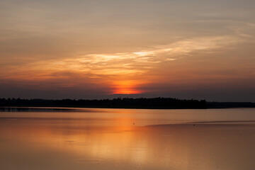 Beautiful stormy sunset. Fiery orange sunset sky.