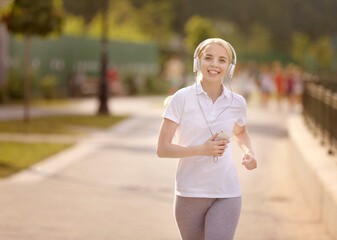 Beautiful girl running in spring park