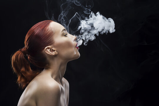 smoking beauty girl portrait on a black background