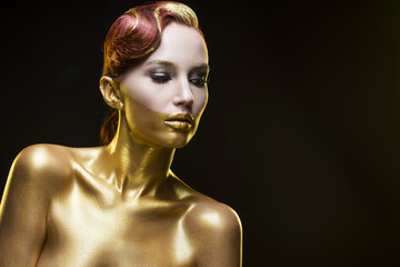 the girl tinted in gold on a black background