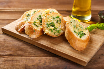 Tasty bread with garlic, cheese and herbs on kitchen table