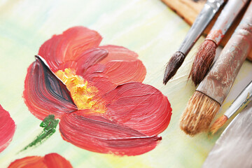 Beautiful oil painted picture with artist equipment, closeup
