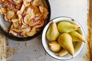 Top view of dried apples and pears in bowls. Rustic vintage style