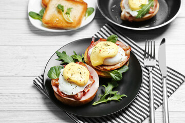Tasty eggs Benedict on plate