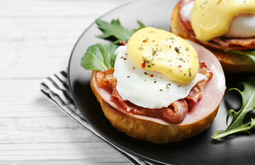 Tasty eggs Benedict on plate