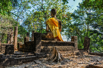 Buddha statue in the forest in Si Satchanalai, Thailand