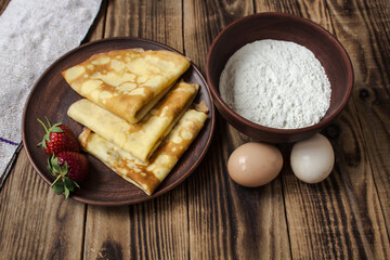 crepes pancakes on plate strawberry flour and eggs