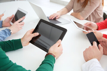Team work concept. People sitting at table in office and using digital devices