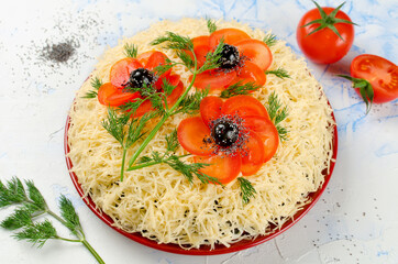 Salad decorated with poppies made of sliced tomatoes and olives