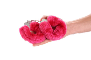 Man holding red furry handcuffs in hand on white background