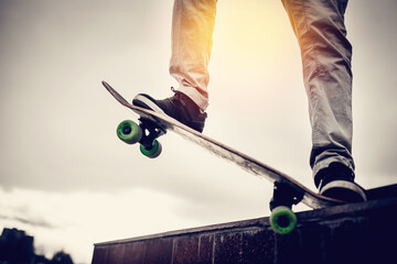 skateboarder guy prepares for a stunt on a skateboard and rides along the road. Concept forward to the goal and achieve it.