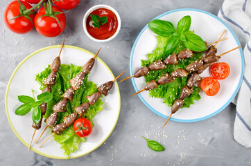 Chicken hearts on a barbecue sticks topped with sesame seeds