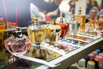 Different perfume bottles in modern shop